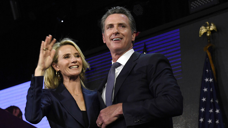 Jennifer Siebel Newsom and Gavin Newsom waving