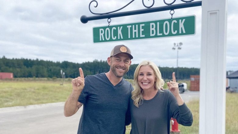 Jenny and Dave Marrs pointing at Rock The Block sign