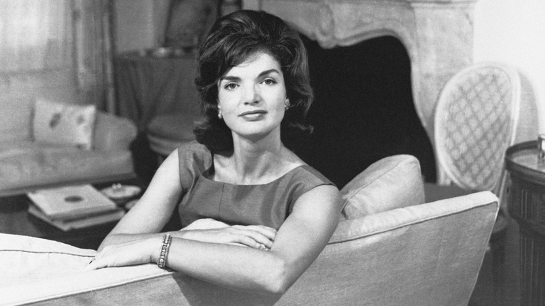 Jackie Kennedy poses on couch