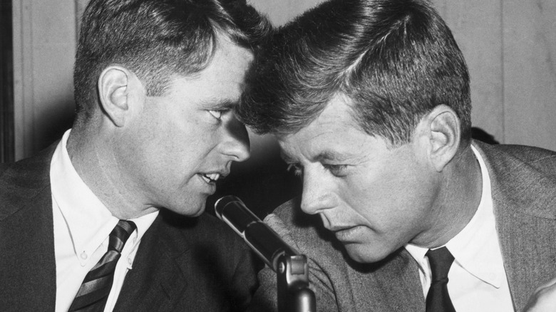 Robert Kennedy whispering to John F Kennedy