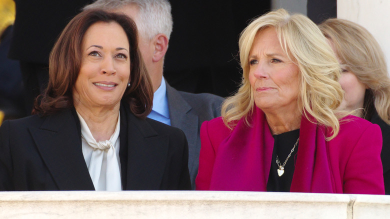 U.S. Vice President Kamala Harris sits with First Lady Jill Biden at a Veterans Day ceremony at Arlington National Cemetery.