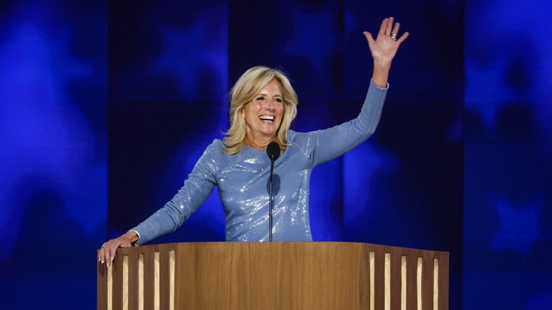 Jill Biden waving in a shiny blue dress