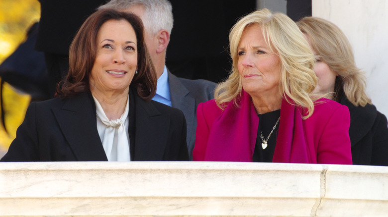 Vice President Kamala Harris sits with First Lady Jill Biden at a Veterans Day ceremony