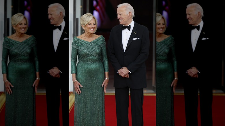 Dr. Jill Biden smiles with Joe Biden on a red carpet