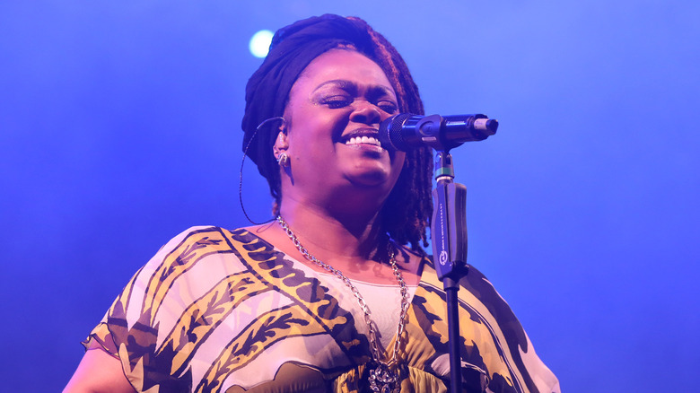 Jill Scott singing into microphone