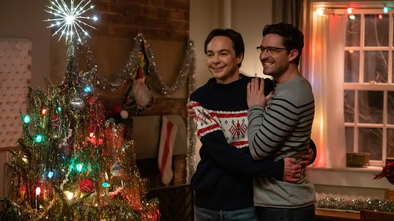 Ben Aldridge and Jim Parsons smiling by Christmas tree in Spoiler Alert