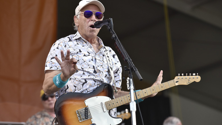 jimmy buffet with guitar on stage