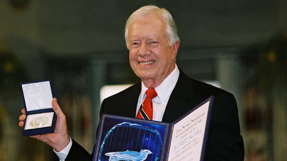 Jimmy Carter posing with his Nobel Peace Prize