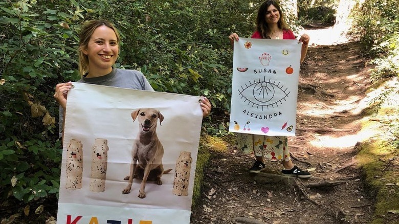 Katie Kimmel with friend holding banner 