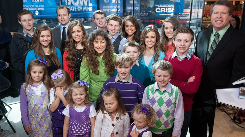 The Duggar family smiling on TV