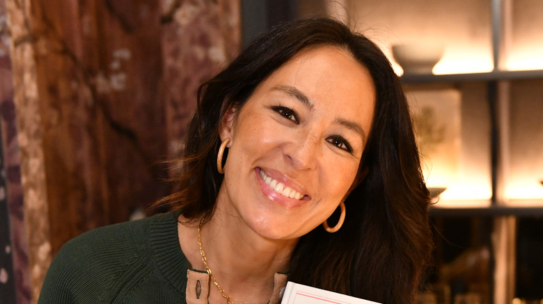 Joanna Gaines holding up a copy of her book