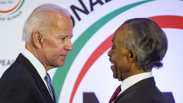 Joe Biden and Rev. Al Sharpton embrace at an event