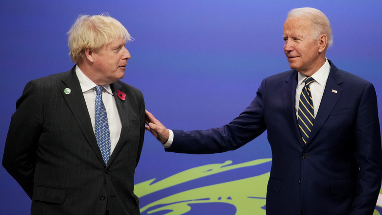 Joe BIden touches Boris Johnson's arm