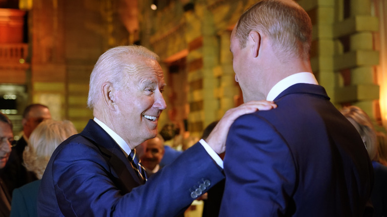 Joe Biden places his hand on Prince William's shoulder