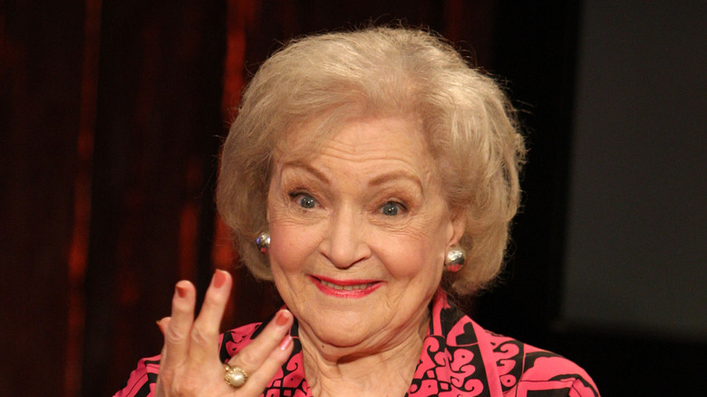 Betty White in a pink and black top