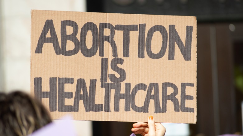 Person holding up pro-choice sign during demonstration