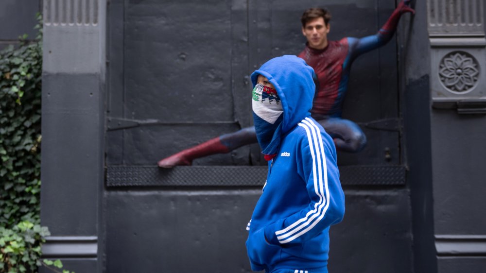 Masked man walking on the street 