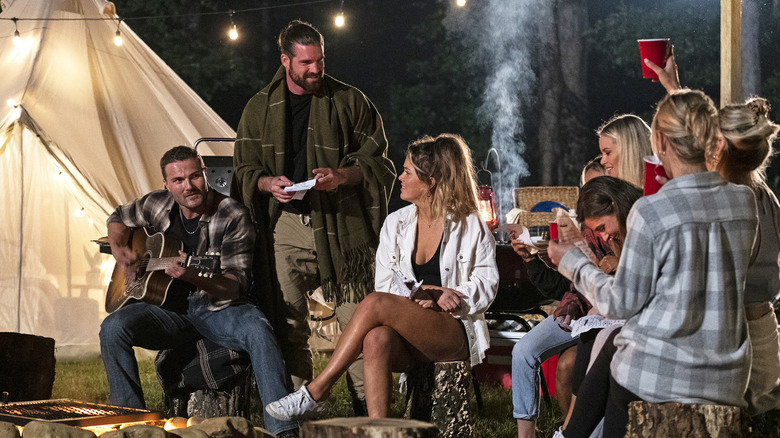 (L-R) Steven, Kurt and contestants in the "Campfire, Cuddles, S'more Drama" episode of JOE MILLIONAIRE: FOR RICHER OR POORER