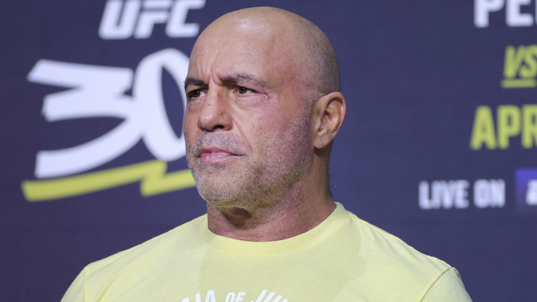 Joe Rogan staring into the distance with a serious look