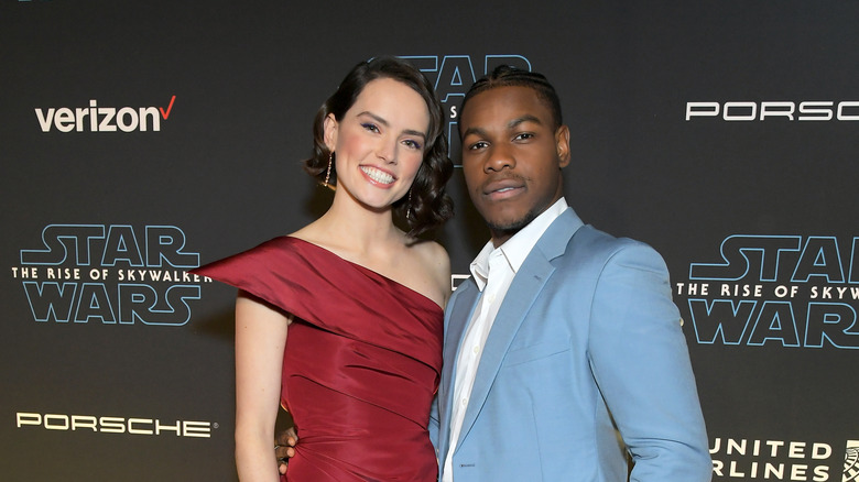 John Boyega and Daisy Ridley smiling 