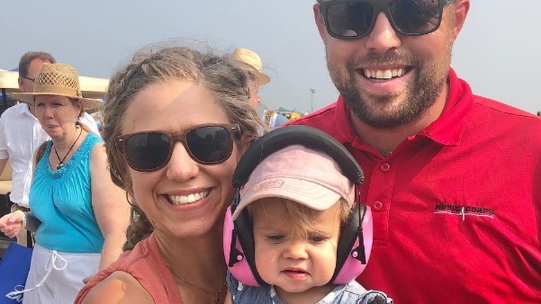 Abbie and John Duggar smiling with their daughter