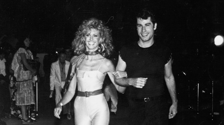 Olivia Newton-John and John Travolta smiling at Grease premiere 