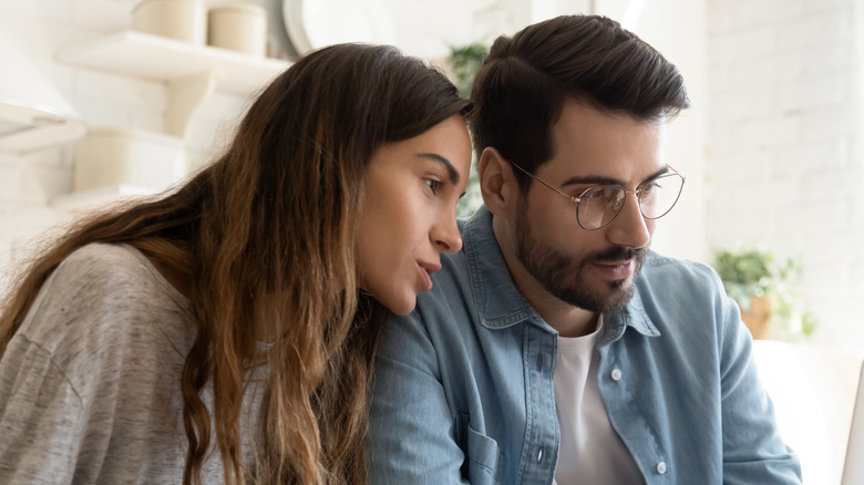 man and woman sitting together