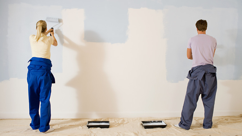 A couple painting their home