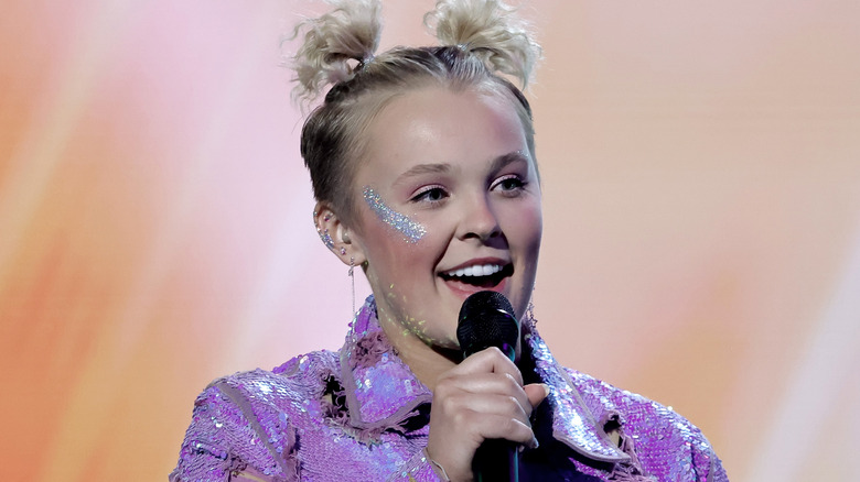 JoJo Siwa holding microphone