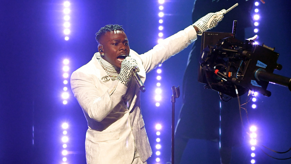 DaBaby performing in white suit