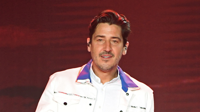 Jonathan Knight performing on stage