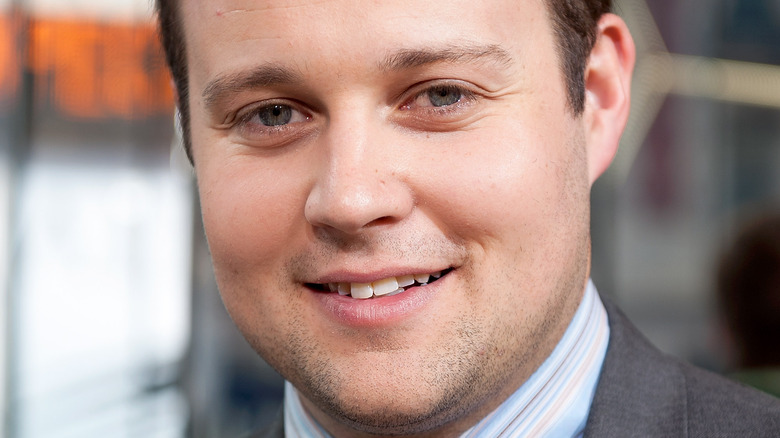 Josh Duggar smiling in a suit