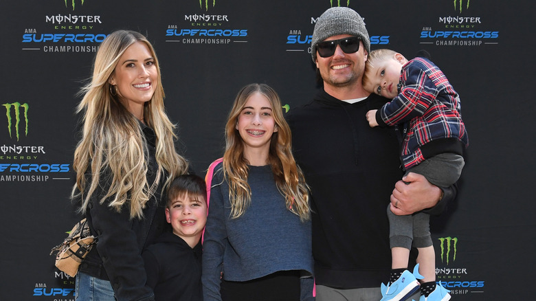 Josh and Christina Hall posing with kids