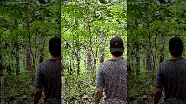 Josh Hall walking in the woods