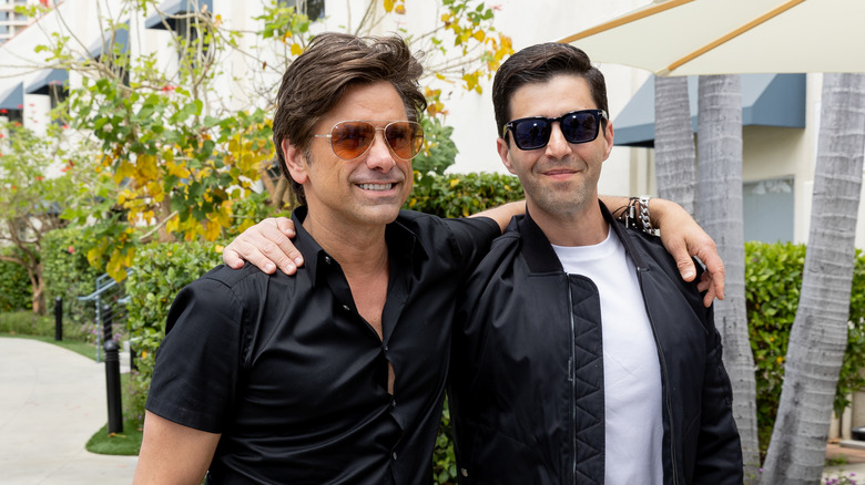 John Stamos with arm around Josh Peck