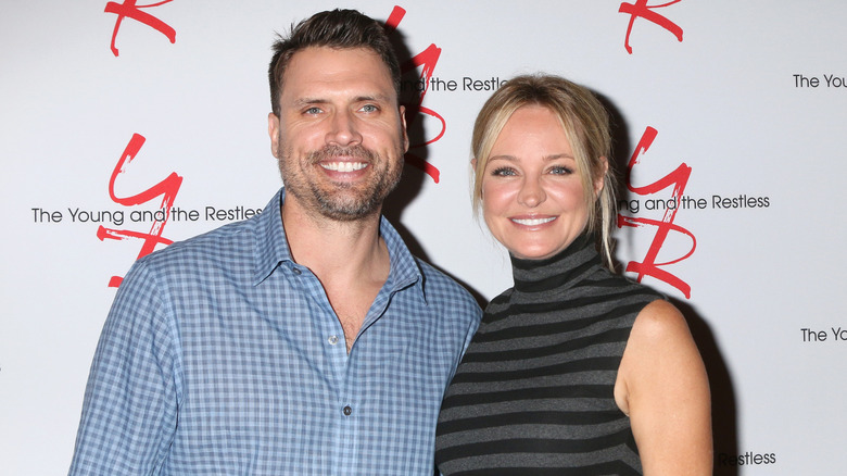 Joshua Morrow and Sharon Case smiling