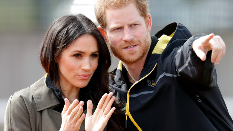 Prince Harry points something out to Meghan Markle