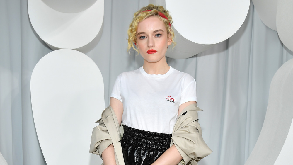 Julia Garner looking serious with red lip and red headband