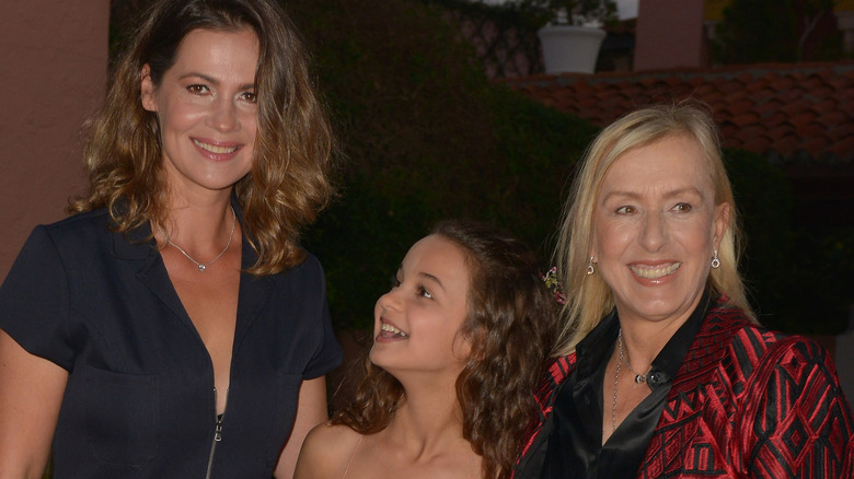 Julia Lemigova, Martina Navratilova, and their daughter standing together