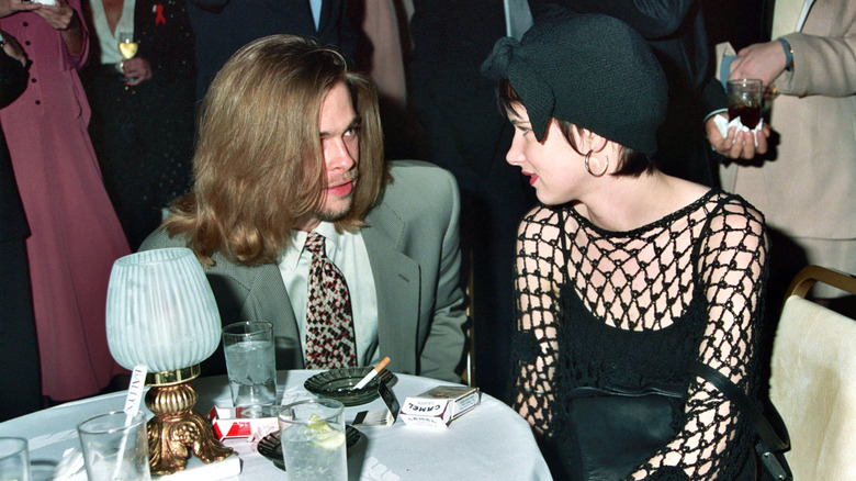 Juliette Lewis and Brad Pitt sitting together 