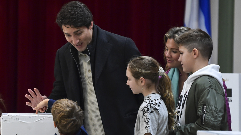 Justin Trudeau standing around a ballot box with Sophie Grégoire and their three children