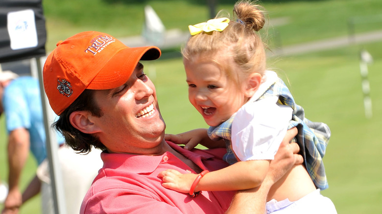 Younger Kai Trump and Donald Trump Jr. on golf course