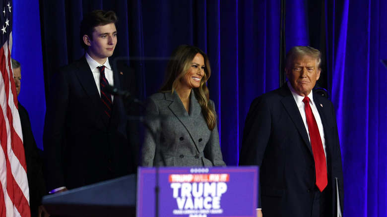 Barron Trump standing on stage behind his parents, Melania and Donald