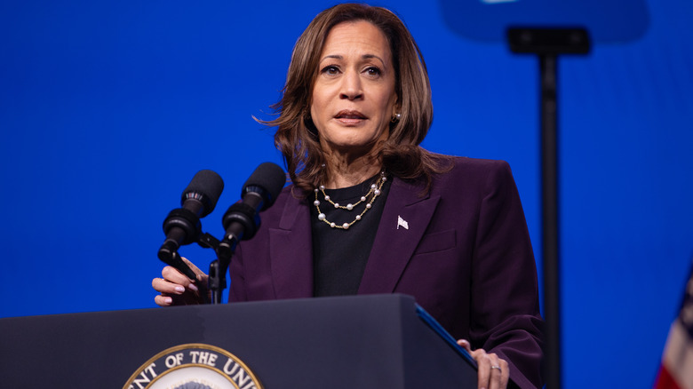 Kamala Harris in purple suit at podium