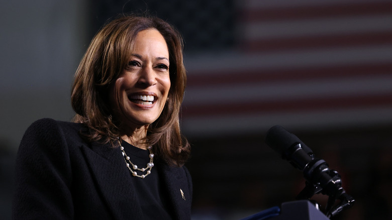 Kamala Harris smiling at a podium