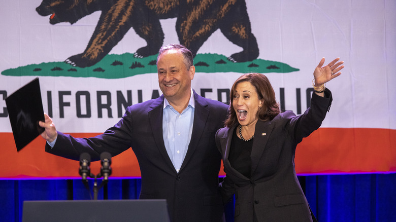 Dough Emhoff and Kamala Harris arms outstretched