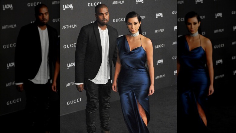 Kanye West and Kim Kardashian posing on the red carpet