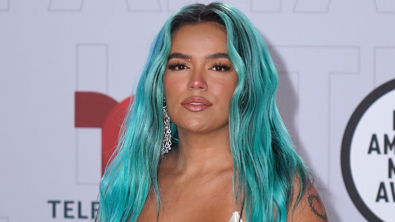 Karol G with blue-green hair