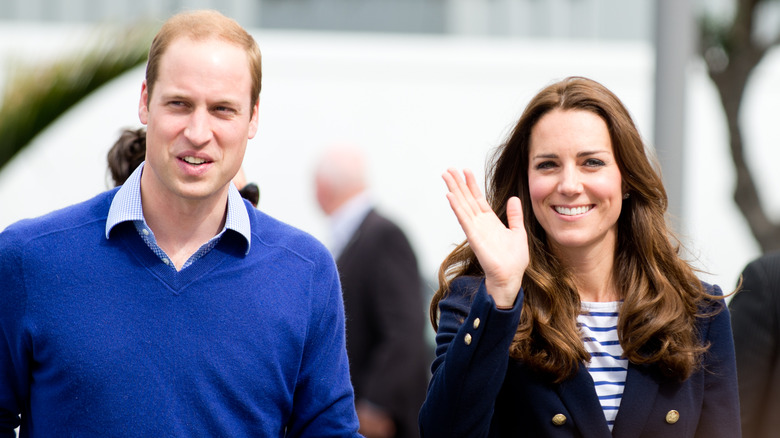 Kate waving and smiling and Prince William smiling in blue sweater