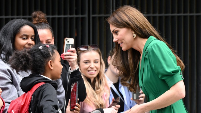 Kate Middleton talking with a child